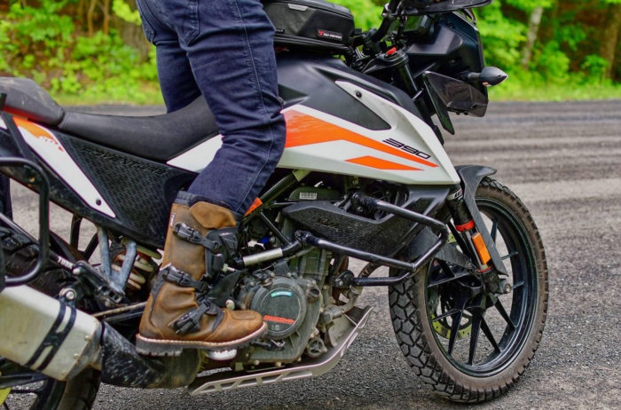 Motorcyclist wearing TCX Drifter WP boots, resting on the foot peg of a road bike