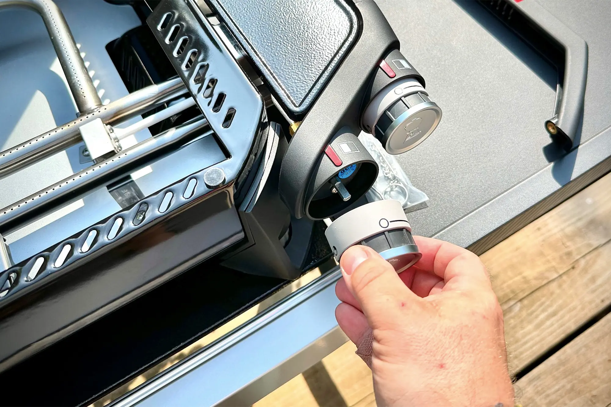 man assembling weber traveler 22 griddle