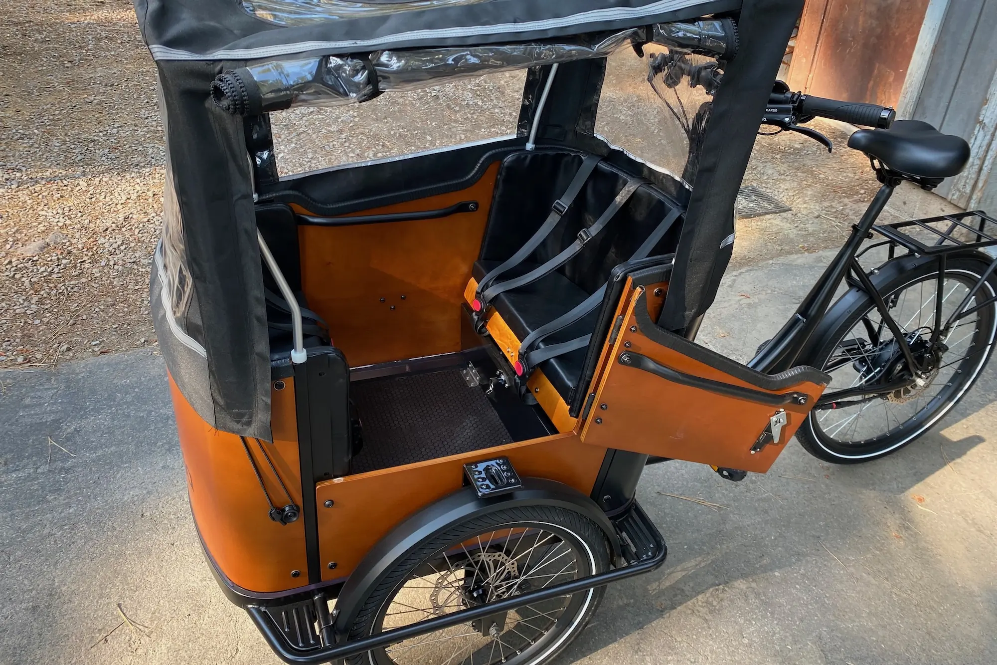 Examining features like the side door and the fully enclosed rain canopy on the Ferla Royce 2 electric cargo bike