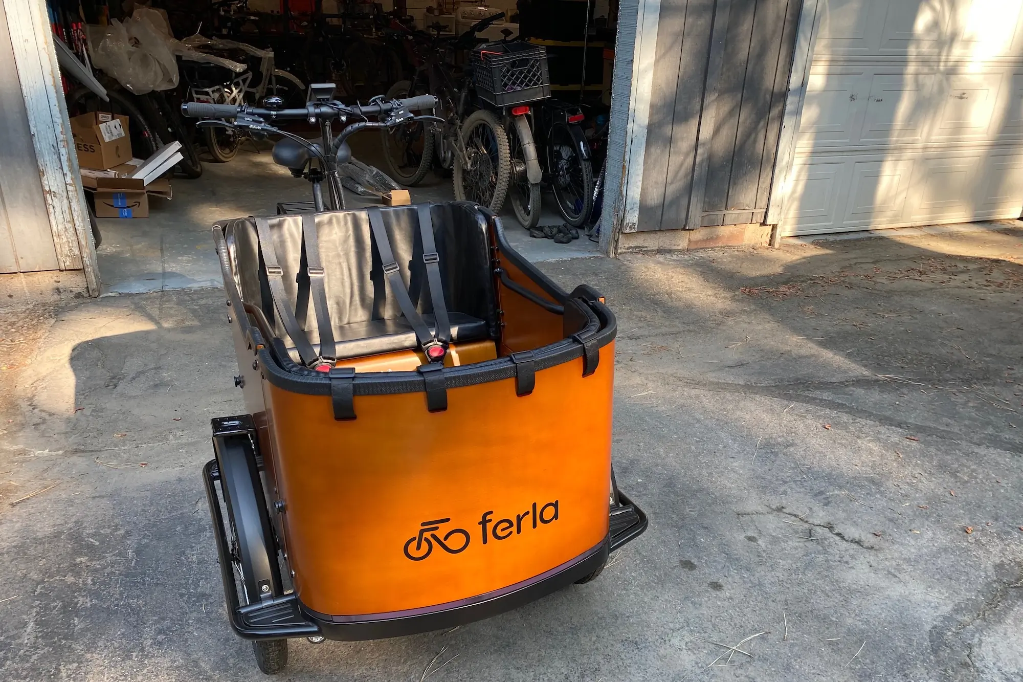 The Ferla Royce 2 electric cargo bike parked in front of an open garage