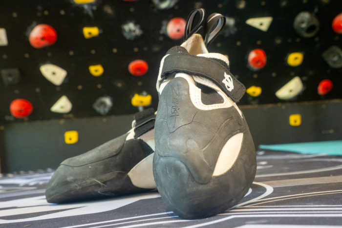 Evolv Zenist Climbing shoe in front of Moonboard