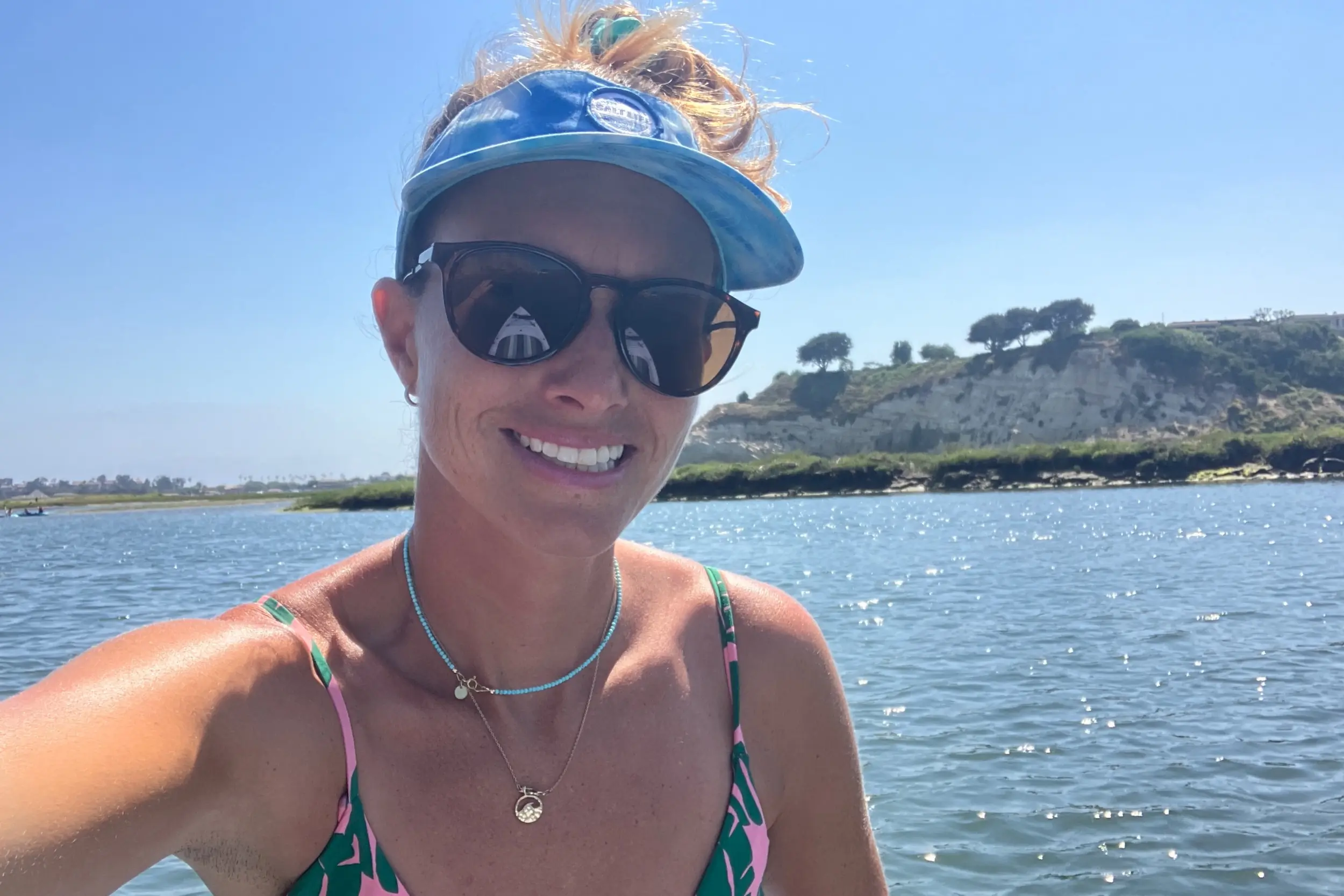Rebecca Parsons wearing the Smith Optics Wander Sunglasses while paddleboarding on the ocean in Hawaii