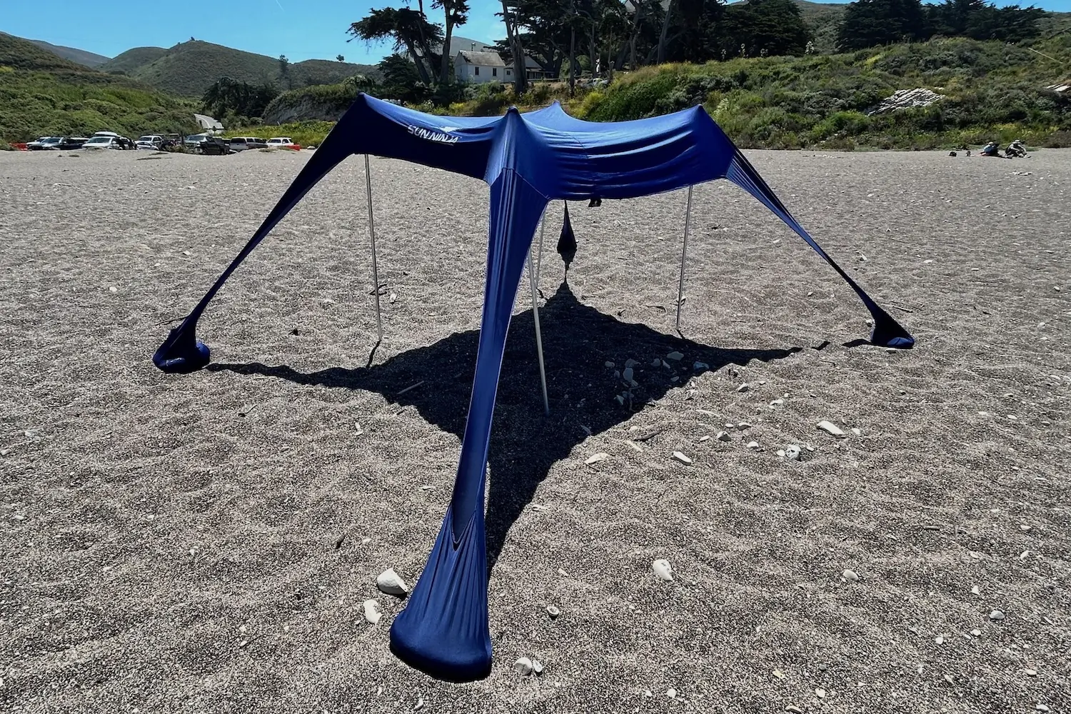The Sun Ninja tent set up on an uncrowded beach on a sunny day