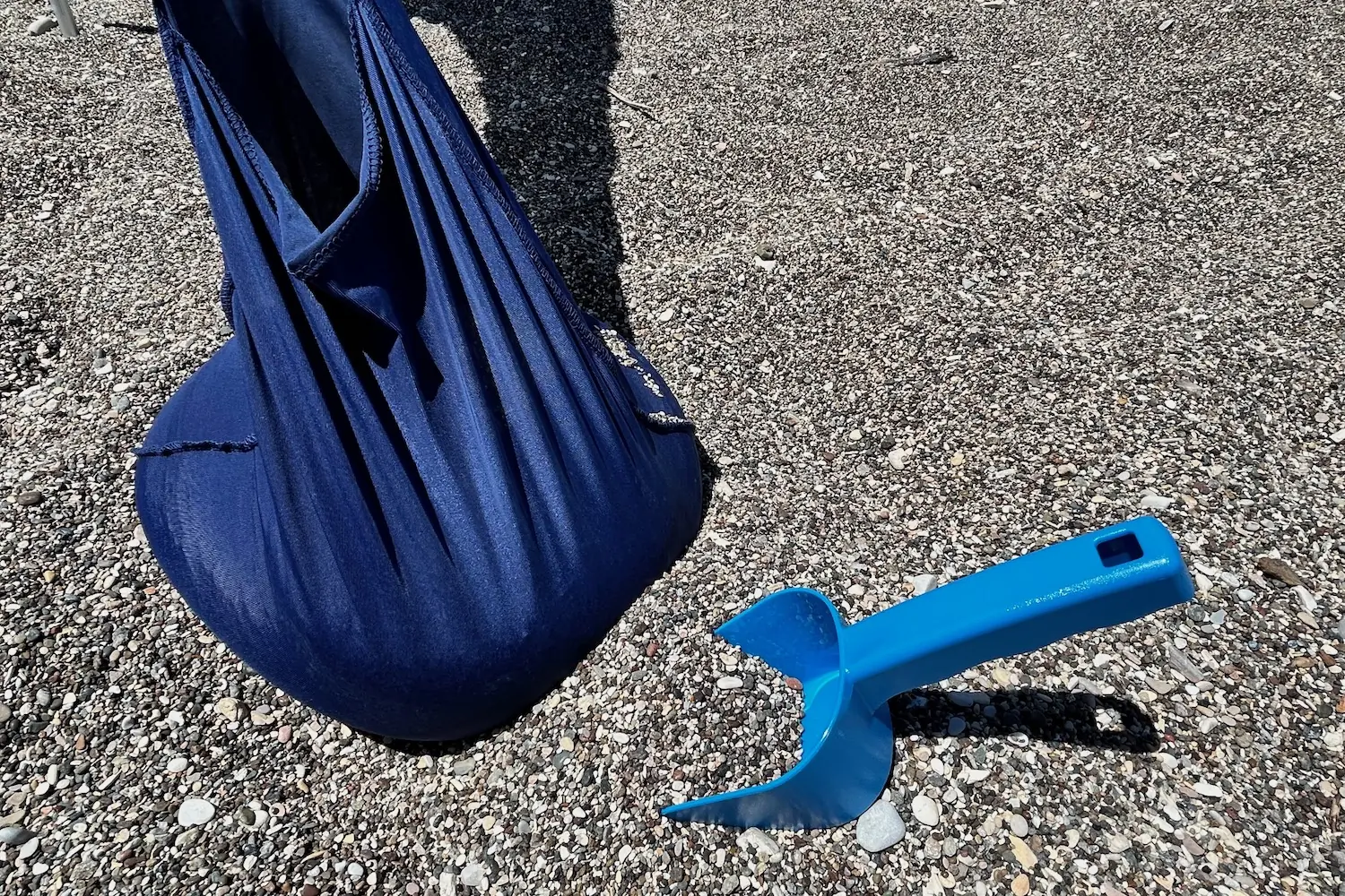 The sandbag anchors on the corners of the Sun Ninja tent along with the included sand scoop