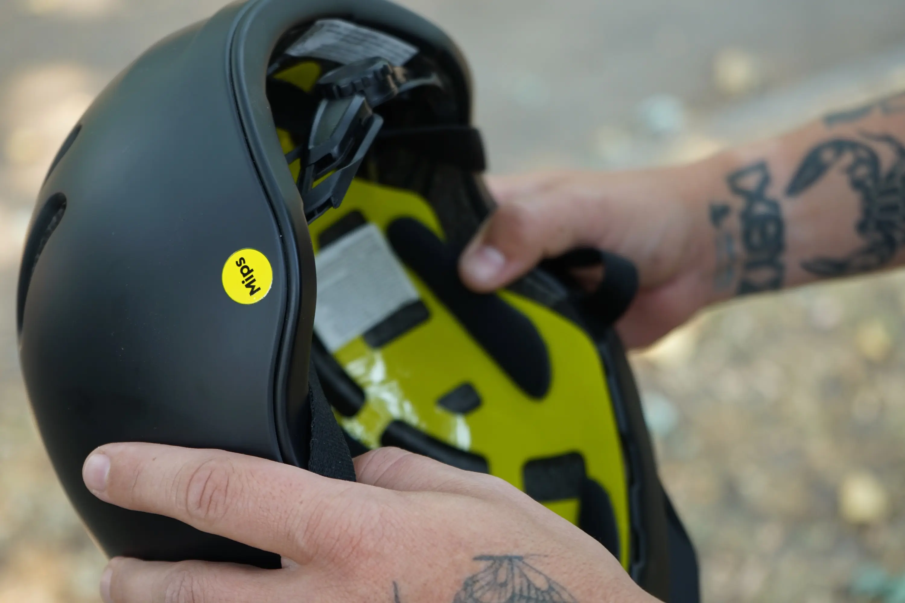 Holding the Thousand Chapter MIPS helmet so the MIPS liner is visible