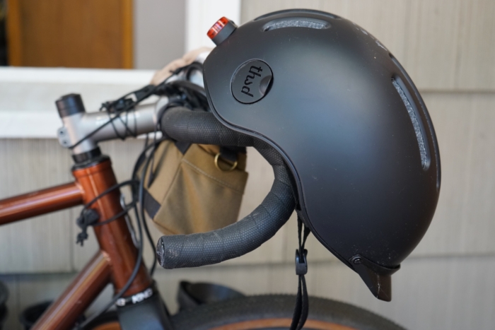 The Thousand Chapter MIPS helmet resting on a bike handlebar