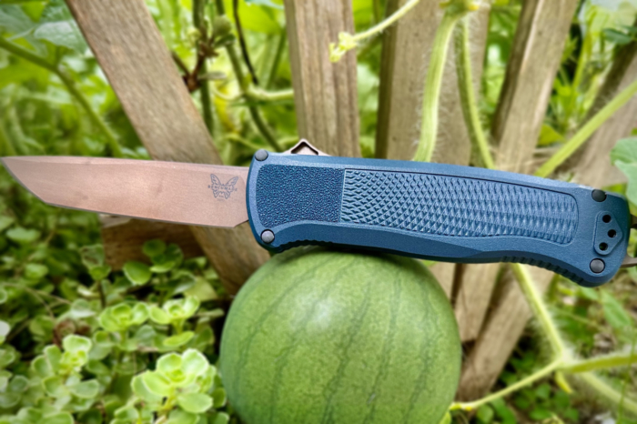 crater blue benchmade shootout otf knife balancing on a watermelon