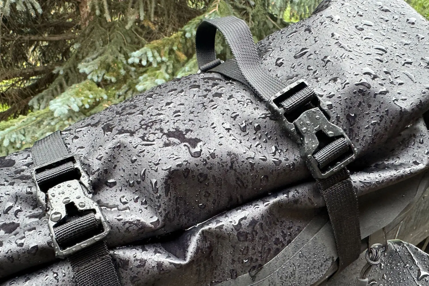 Close-up of a waterproof bikepacking bag with rain droplets