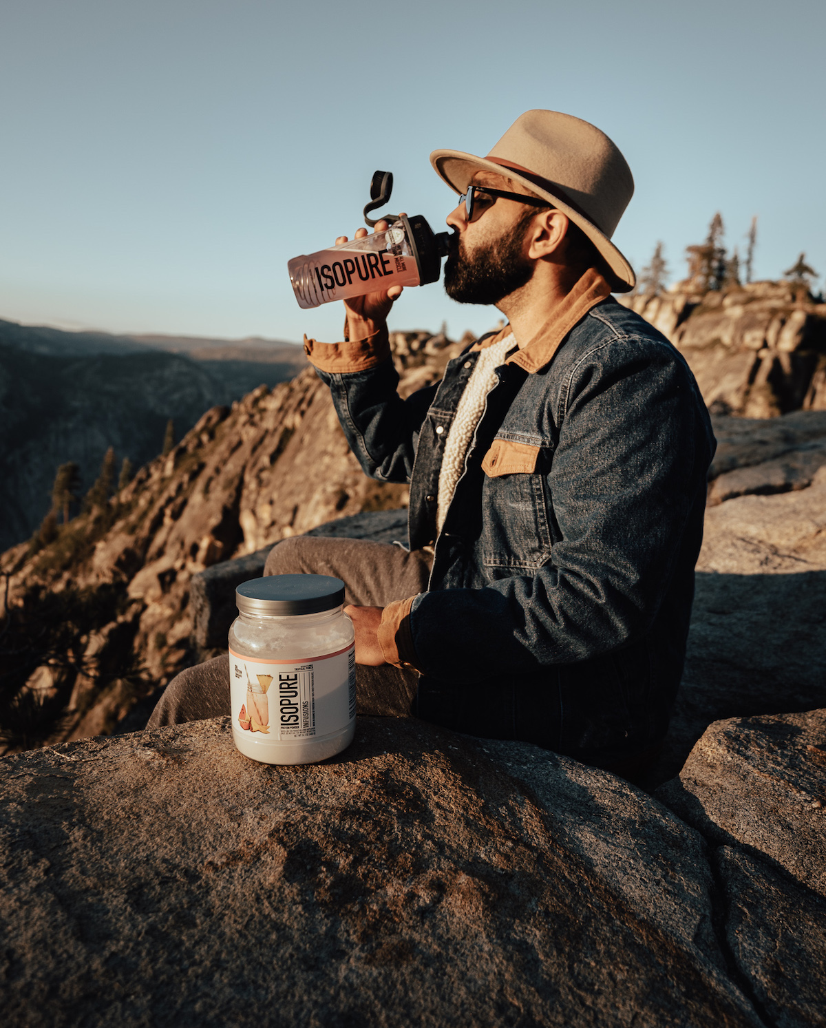 man drinking from isopure shaker
