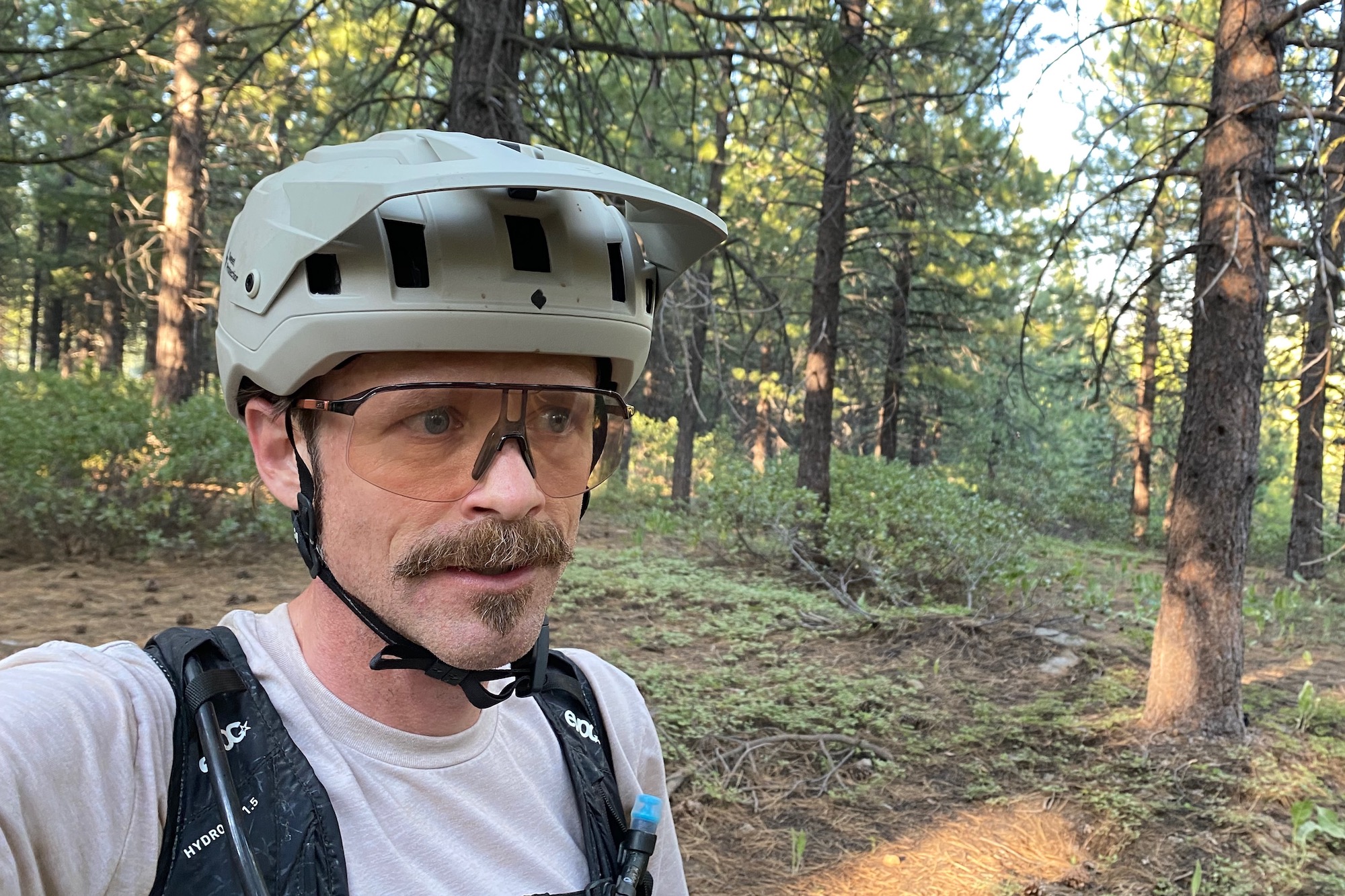 The author wearing the Sweet Protection Bushwhacker 2Vi MIPS to demonstrate a proper mountain bike helmet fit.