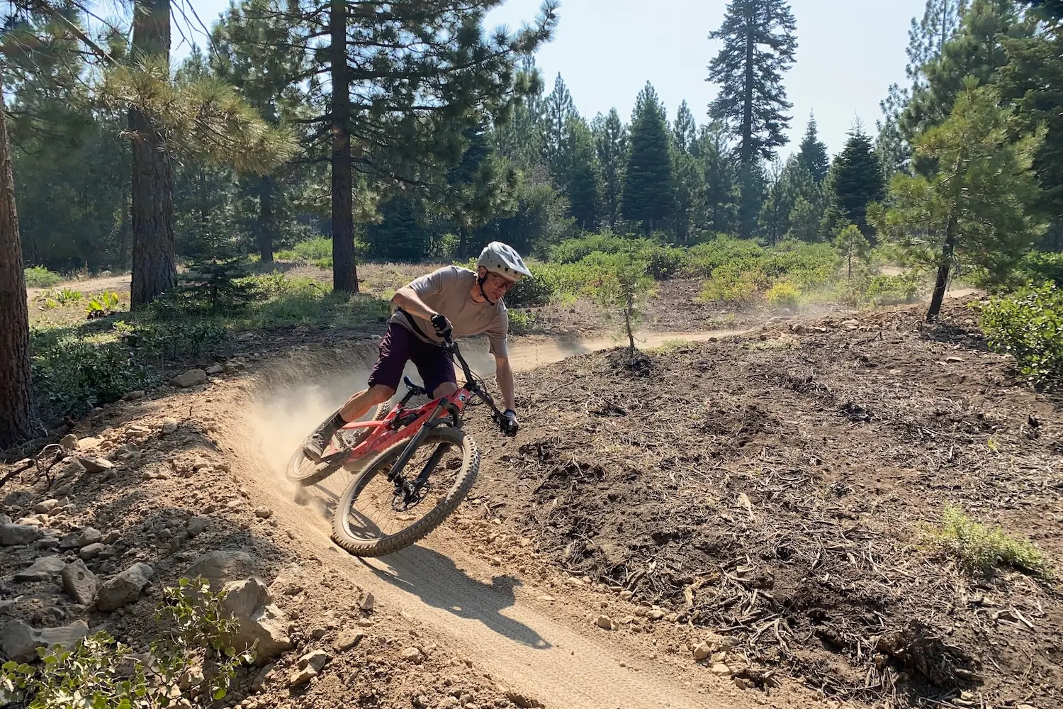 The author mountain biking through a bermed turn while testing mountain bike shorts