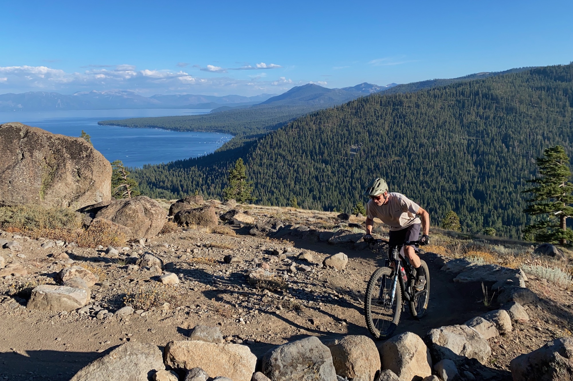 The author climbing up a mountain bike trail high above lake Tahoe while testing mountain bike shorts
