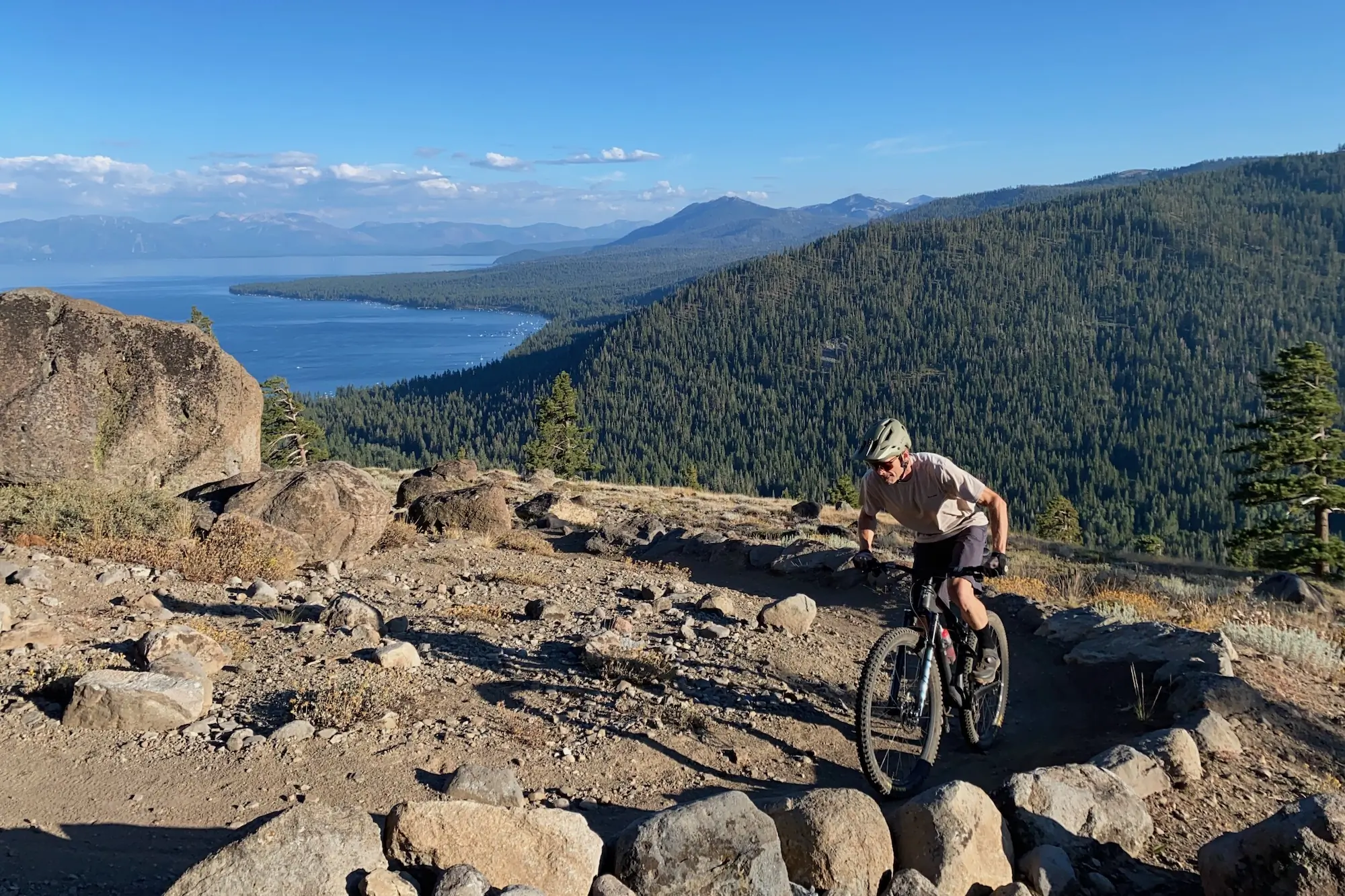 The author climbing up a mountain bike trail high above lake Tahoe while testing mountain bike shorts