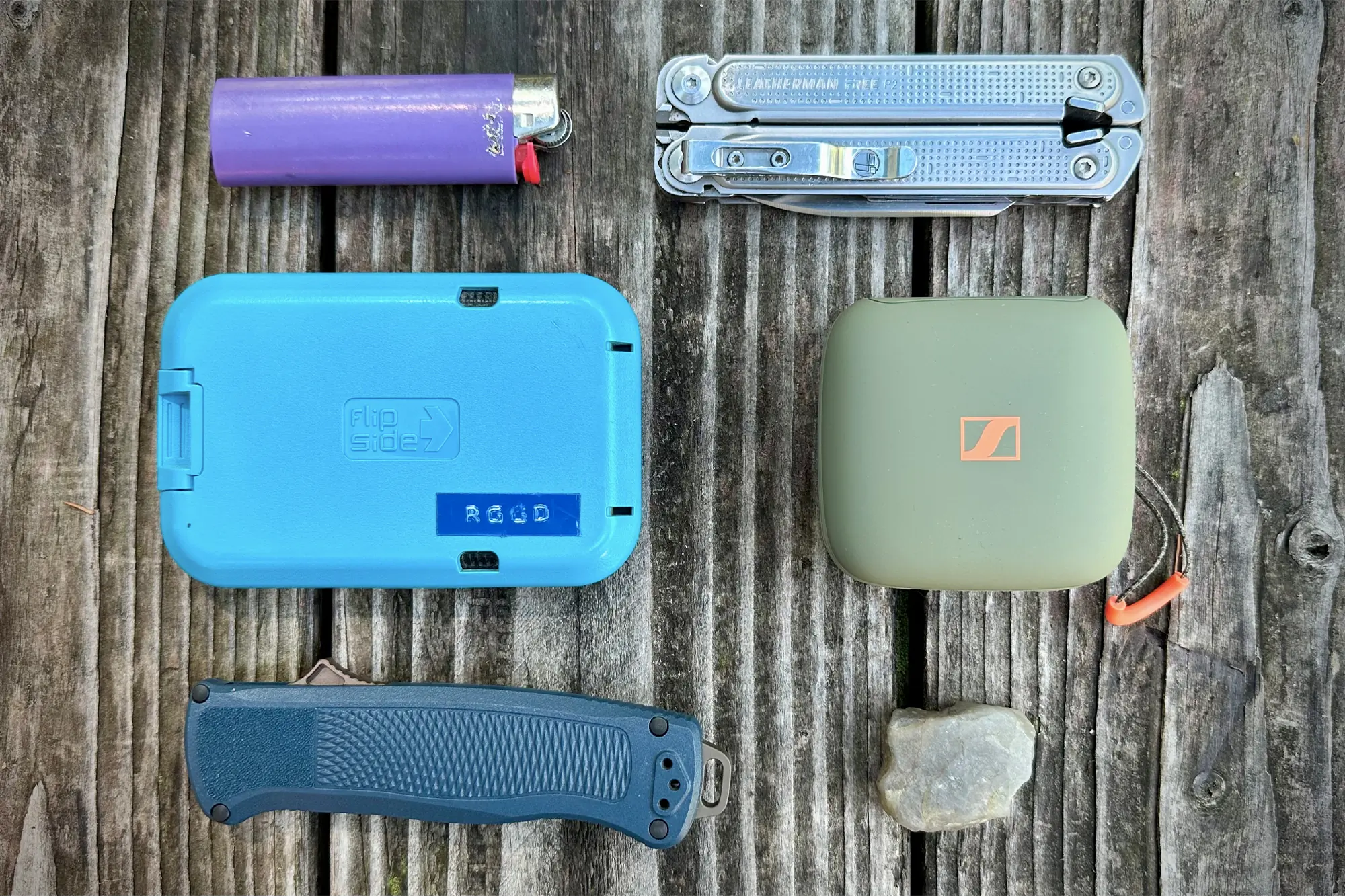 sennheiser momentum sport earbud next to the lighter pocket knife