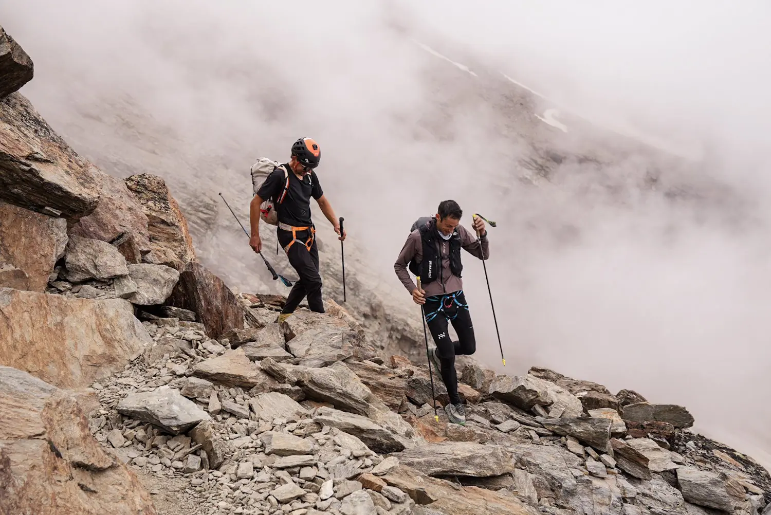 Two climbers descending a rocky trail