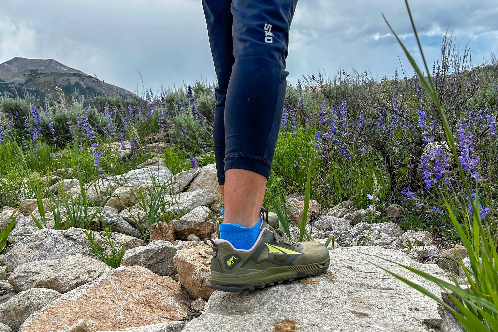 woman wearing altra lone peak 8 shoes with beautiful nature in the background