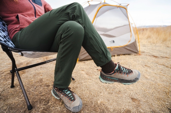 a close-up of a woman's legs wearing green outdoor research ferrosi pants