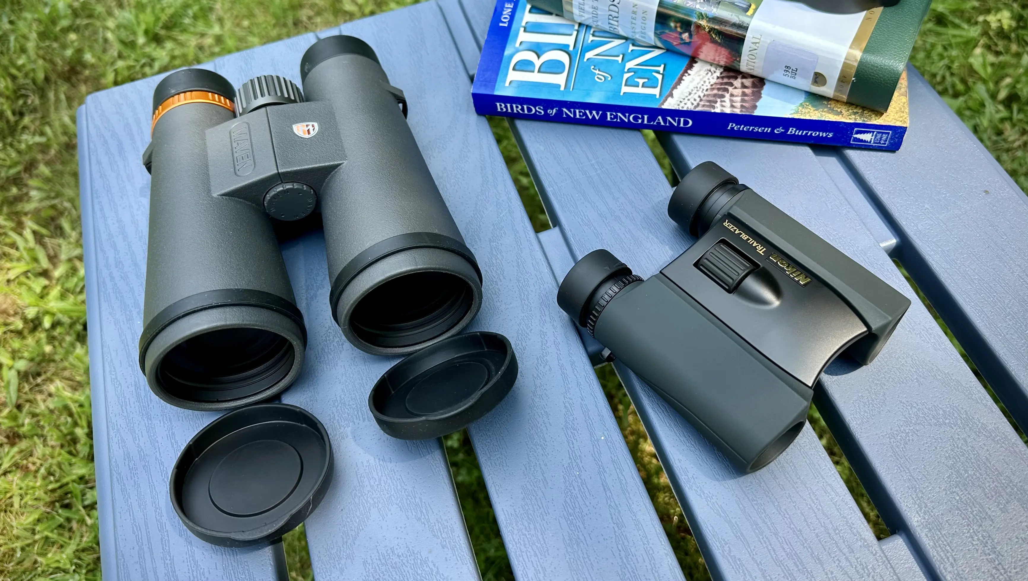 Maven and Nikon binoculars on table with birding books
