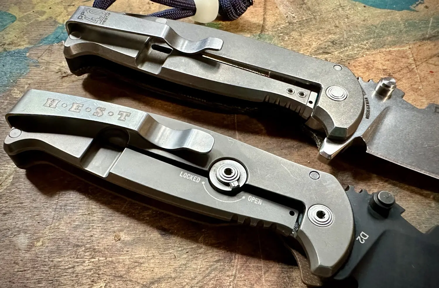 Close-up view of two DPx Gear HEST/F 4.0 folding knives featuring the RotoBlock locking mechanism