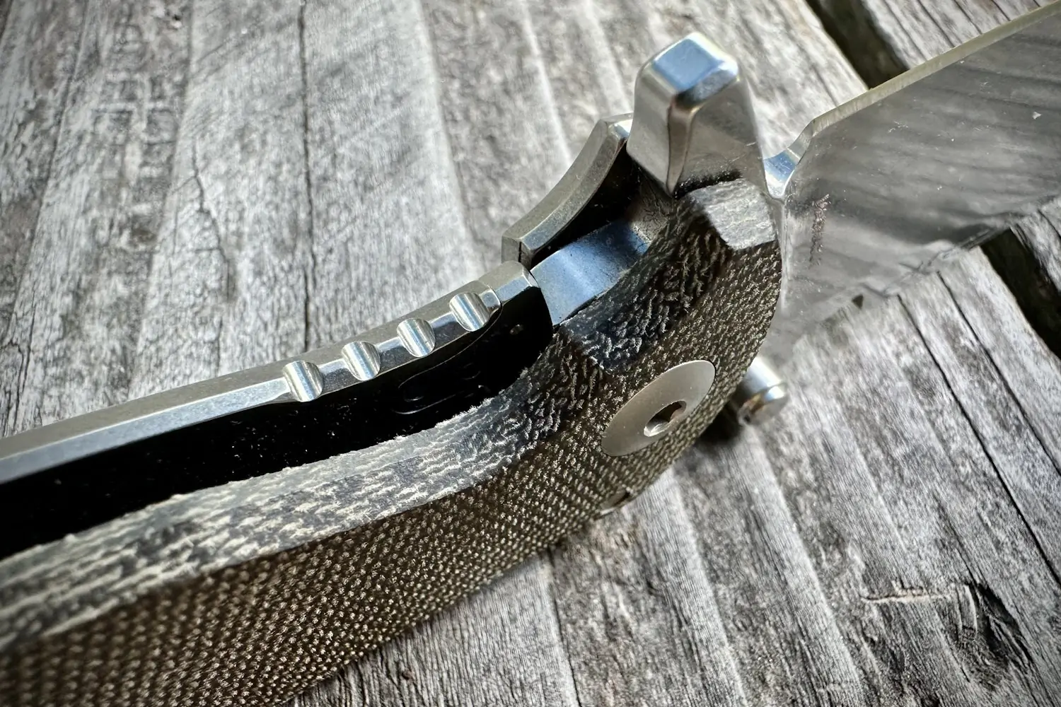 Close-up of the DPx Gear HEST/F 4.0 knife's textured handle 