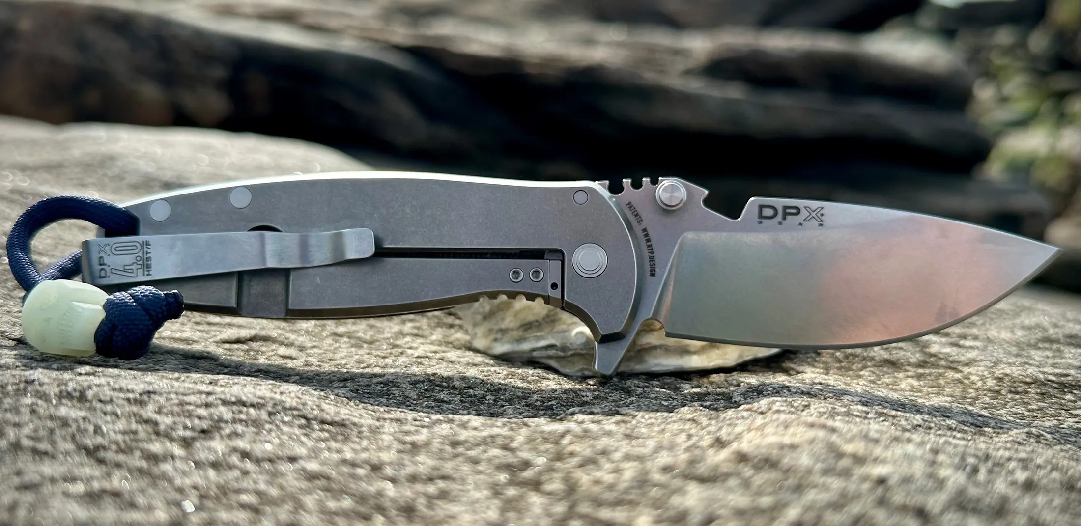 DPx HEST/F 4.0 knife on rock at a beach