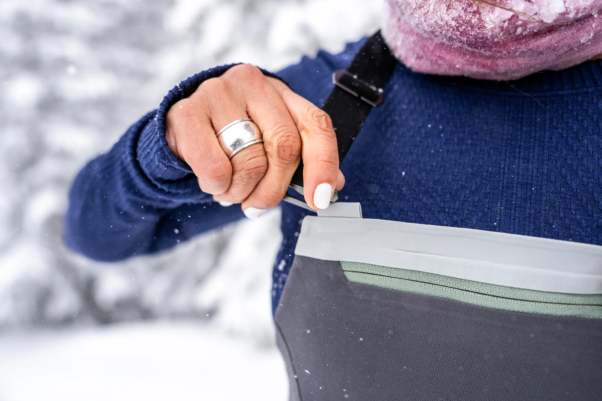 a woman demonstrating a detachable bib strap 