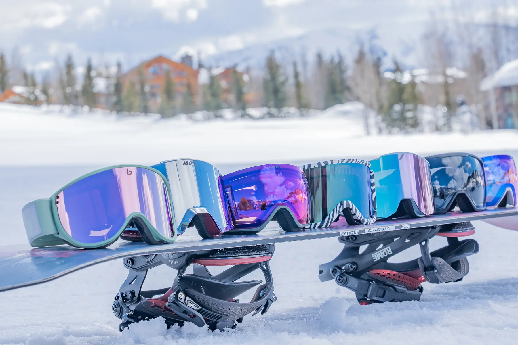 a lineup of goggles on a snowboard at a ski resort