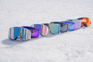 a lineup of snow goggles on the snow