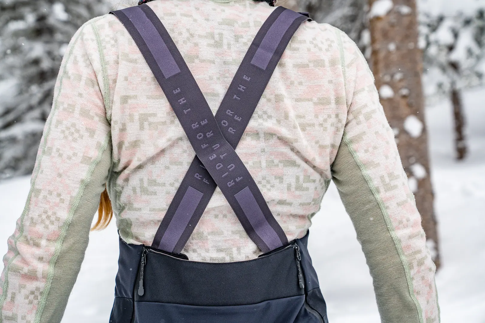 woman standing with back towards camera wearing heavy base layer top