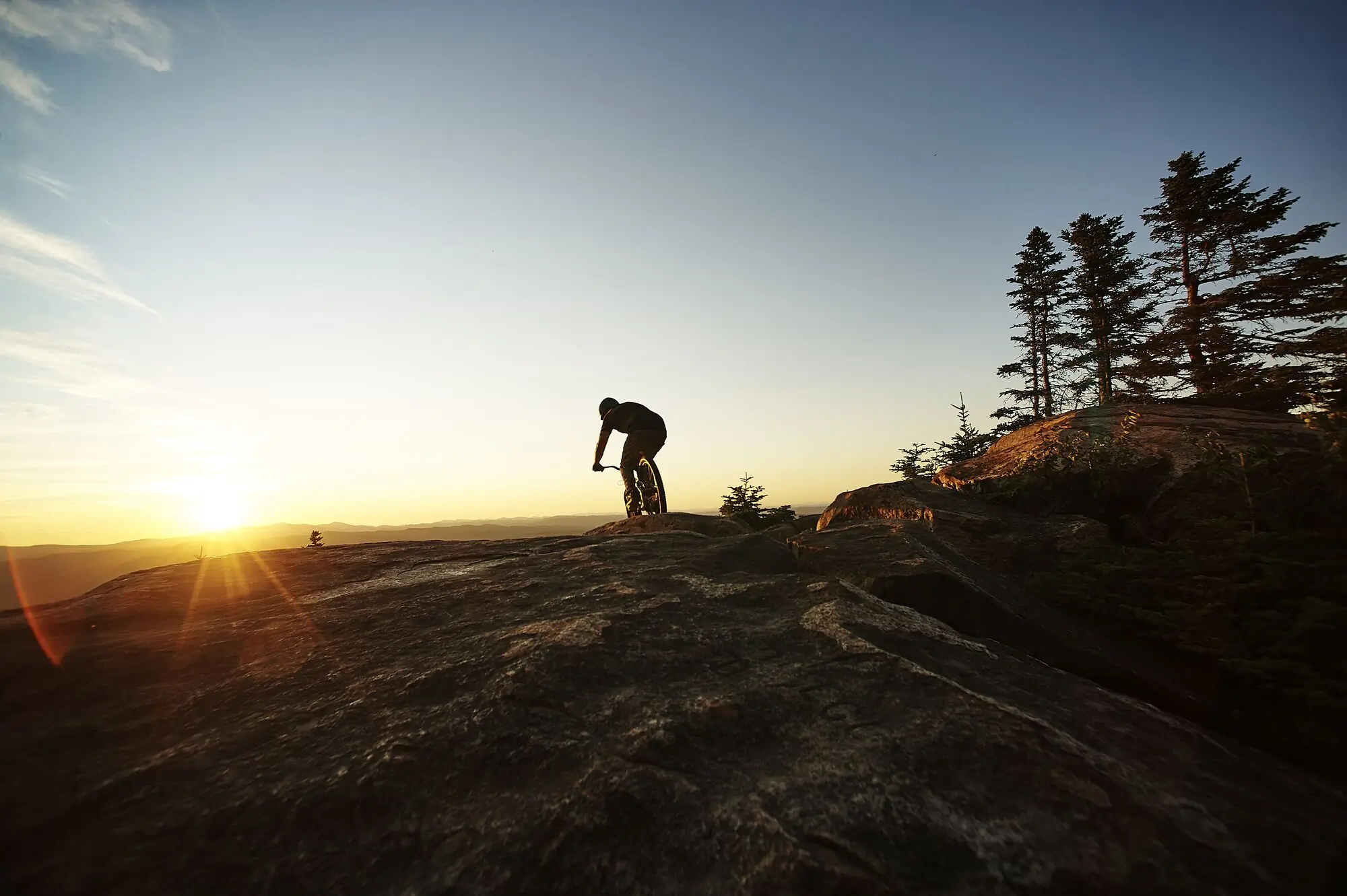 A mountain biker riding at sunrise in Vermont.