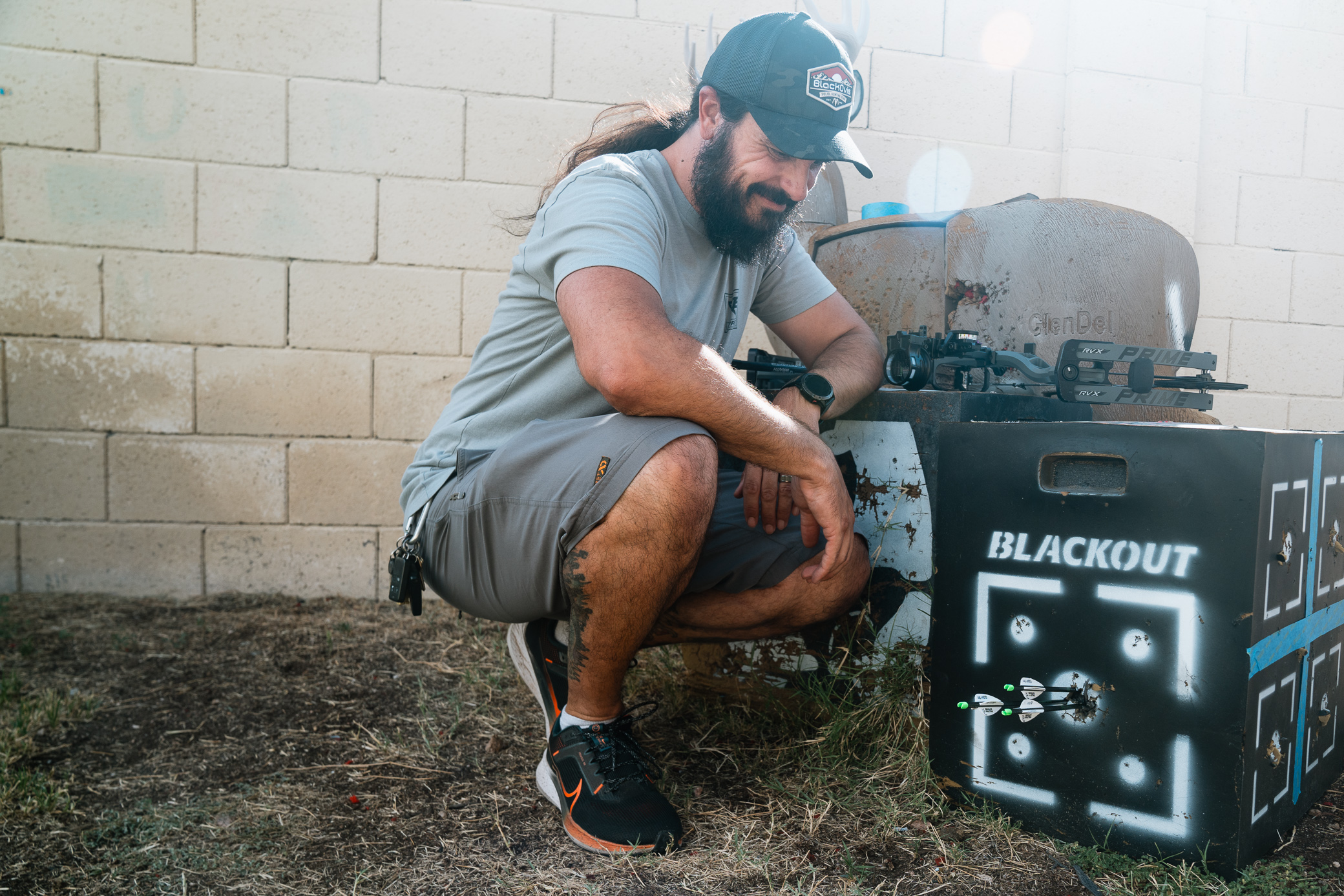 author next to the target with accurately shot arrows