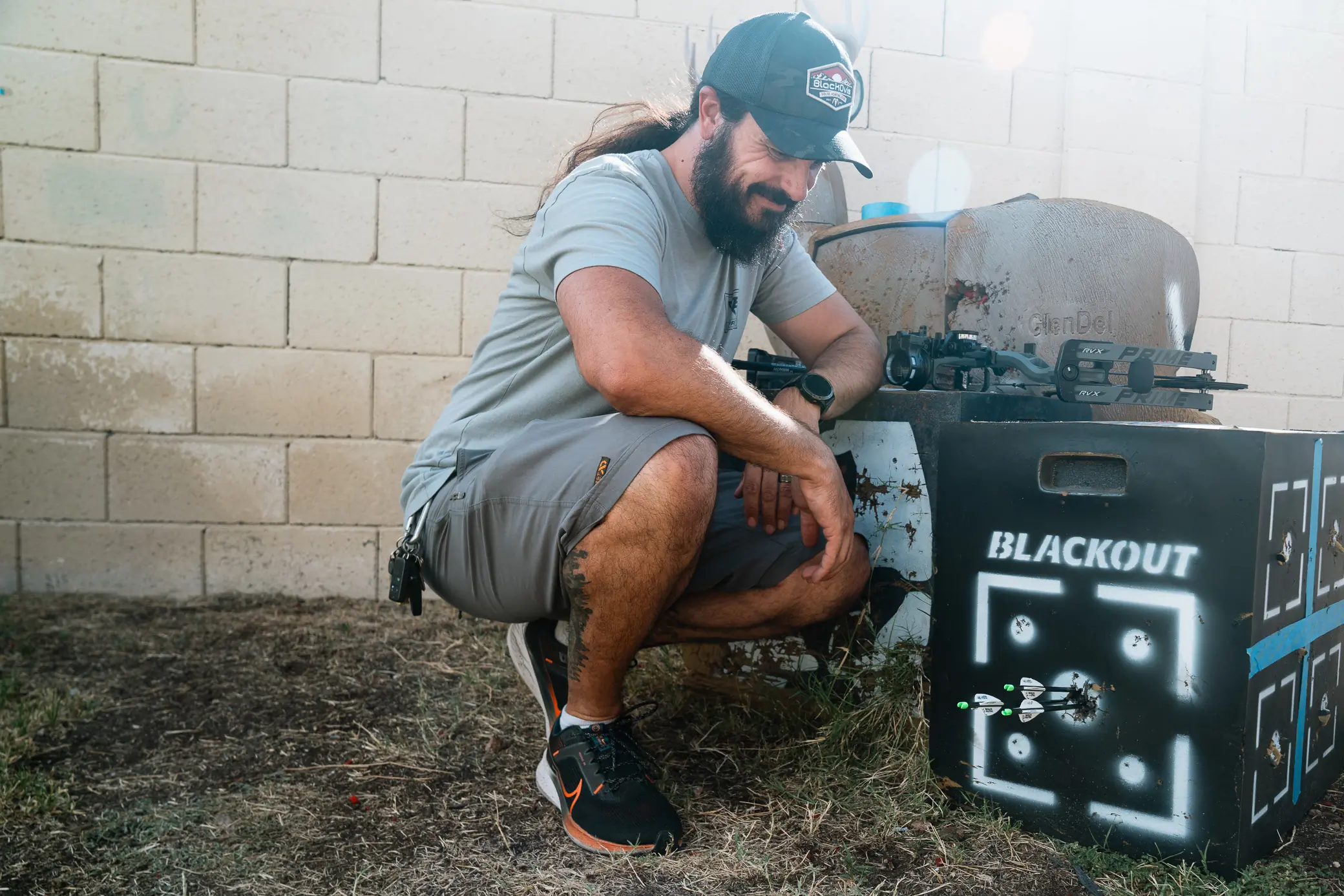 author next to the target with accurately shot arrows