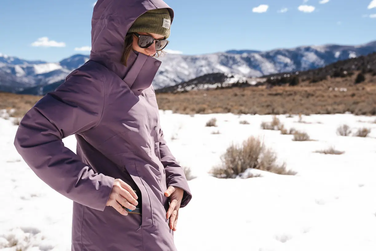 Marmot Women’s Chelsea Coat with woman putting phone in pocket