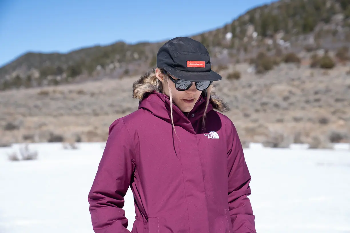 front view of the The North Face Women’s Arctic Parka being worn by woman with hat and sunglasses