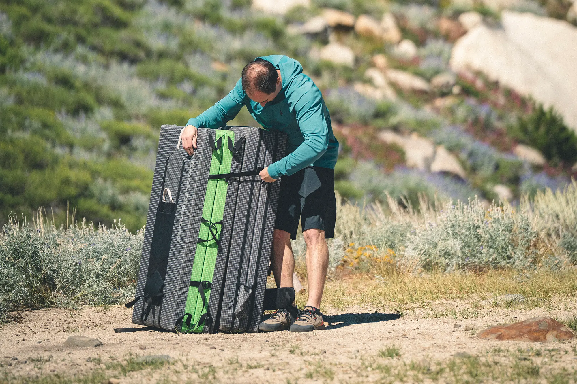 man unpacking black diamond erratic crash pad 4