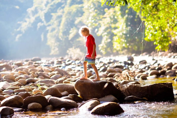 child hiking in river Alps