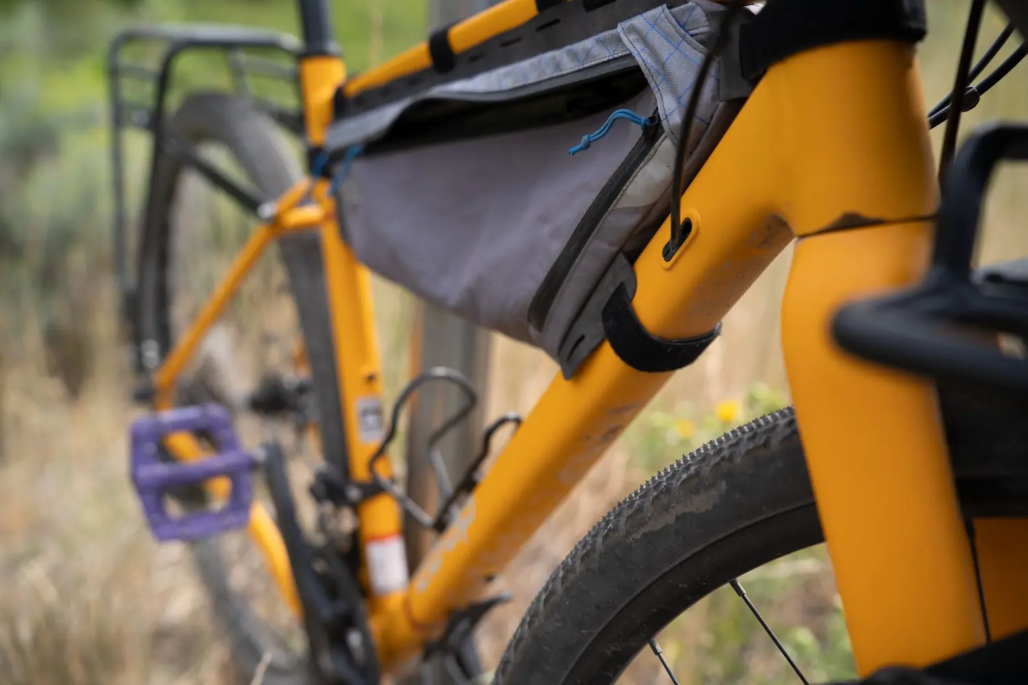 A close-up shot of a yellow REI ADV 2.2 bike, highlighting the frame bag