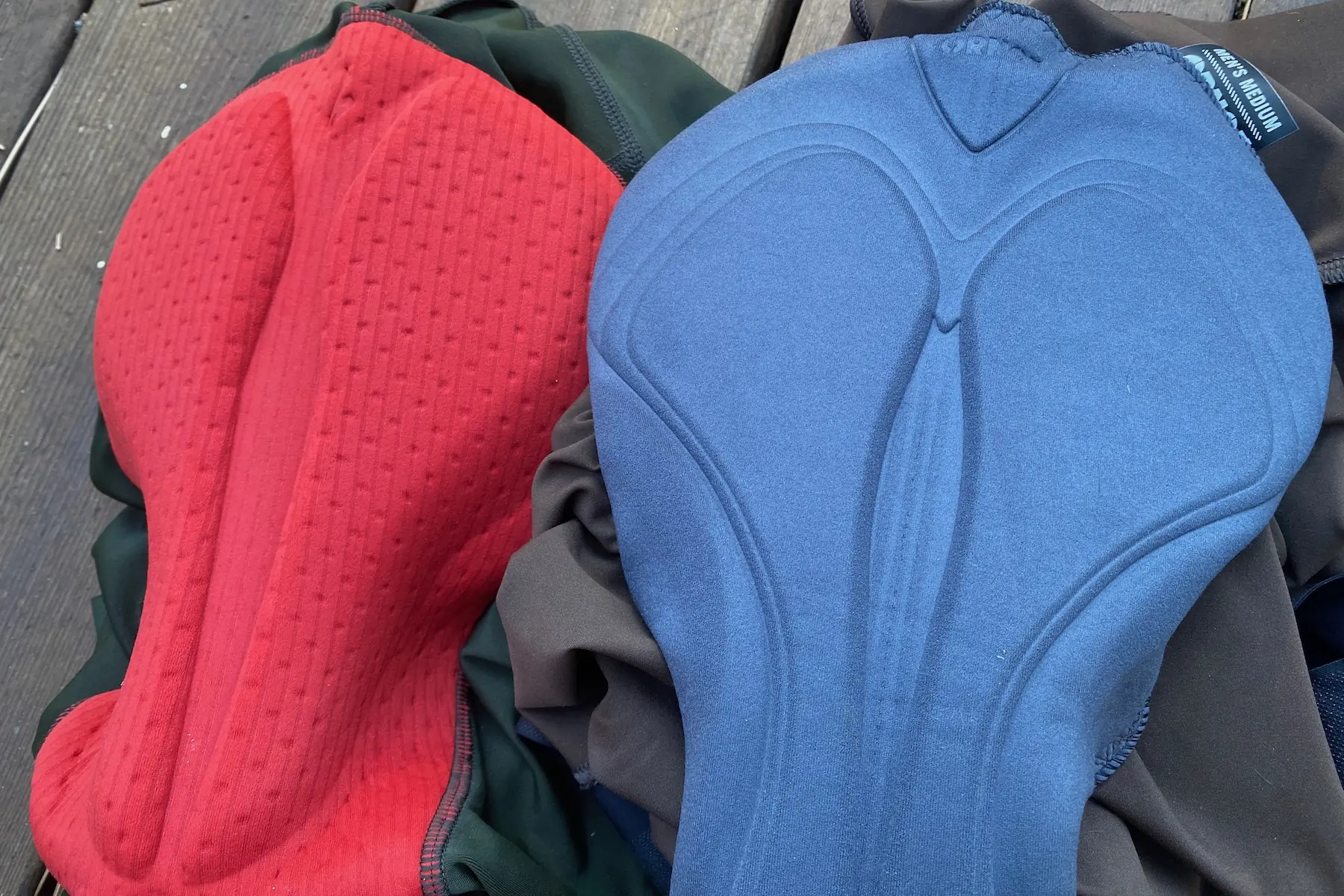 A comparative shot of two chamois pads in the Specialized Foundation Bibs and the Ornot Cargo Bibs