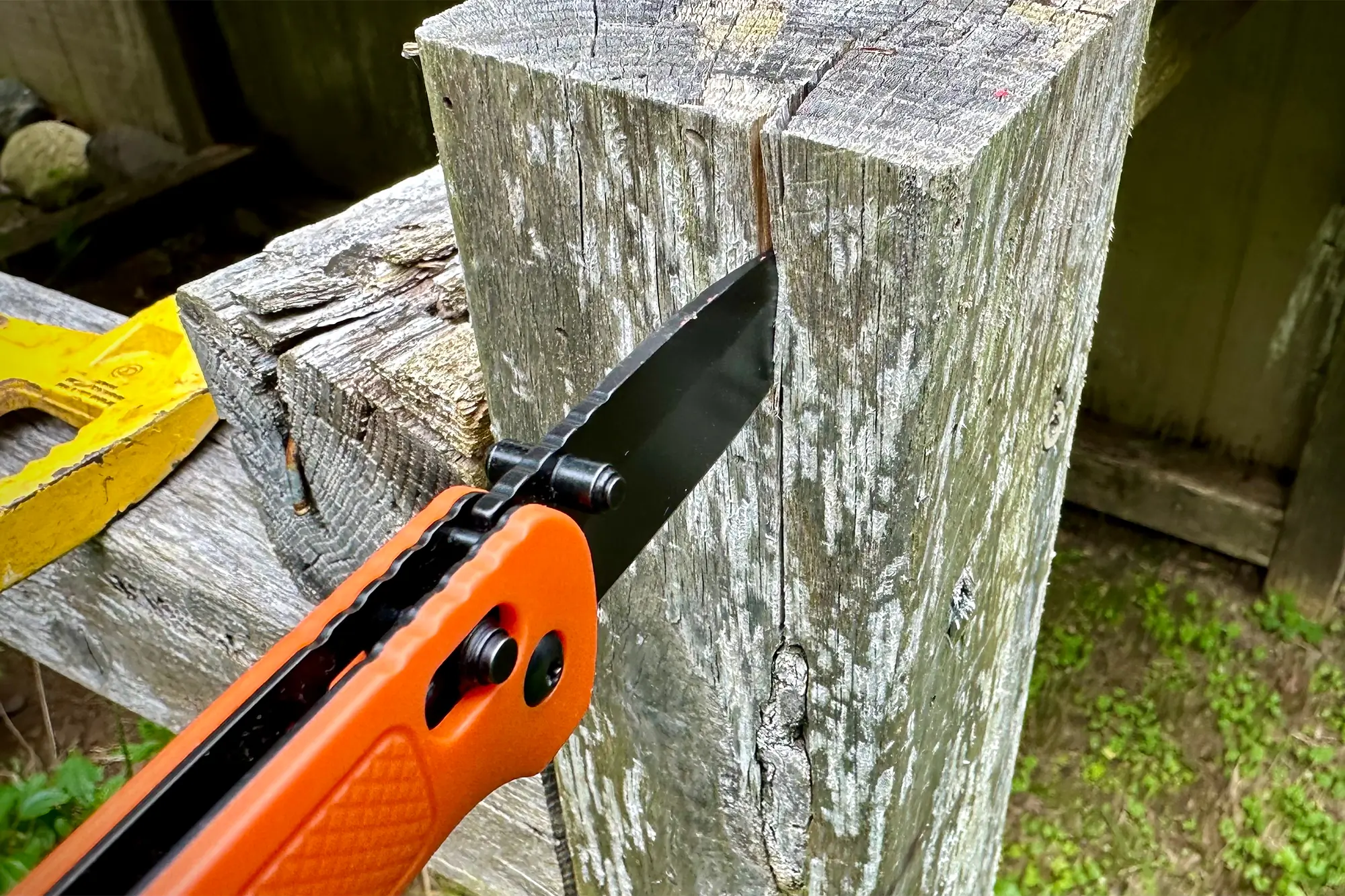 ozark trail 7.5in knife wedged into piece of wood