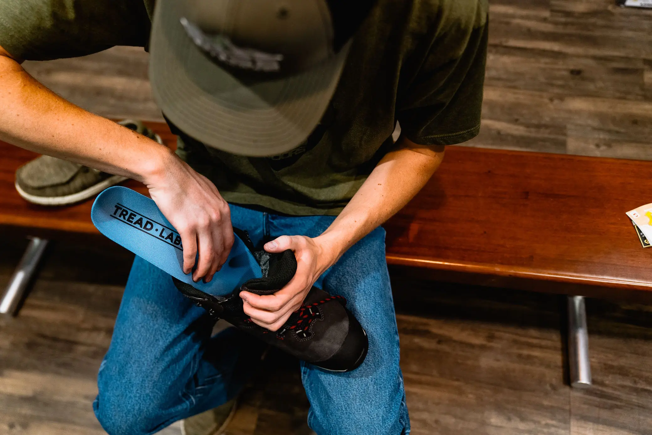 Person placing a Tread Labs insole into a hiking boot