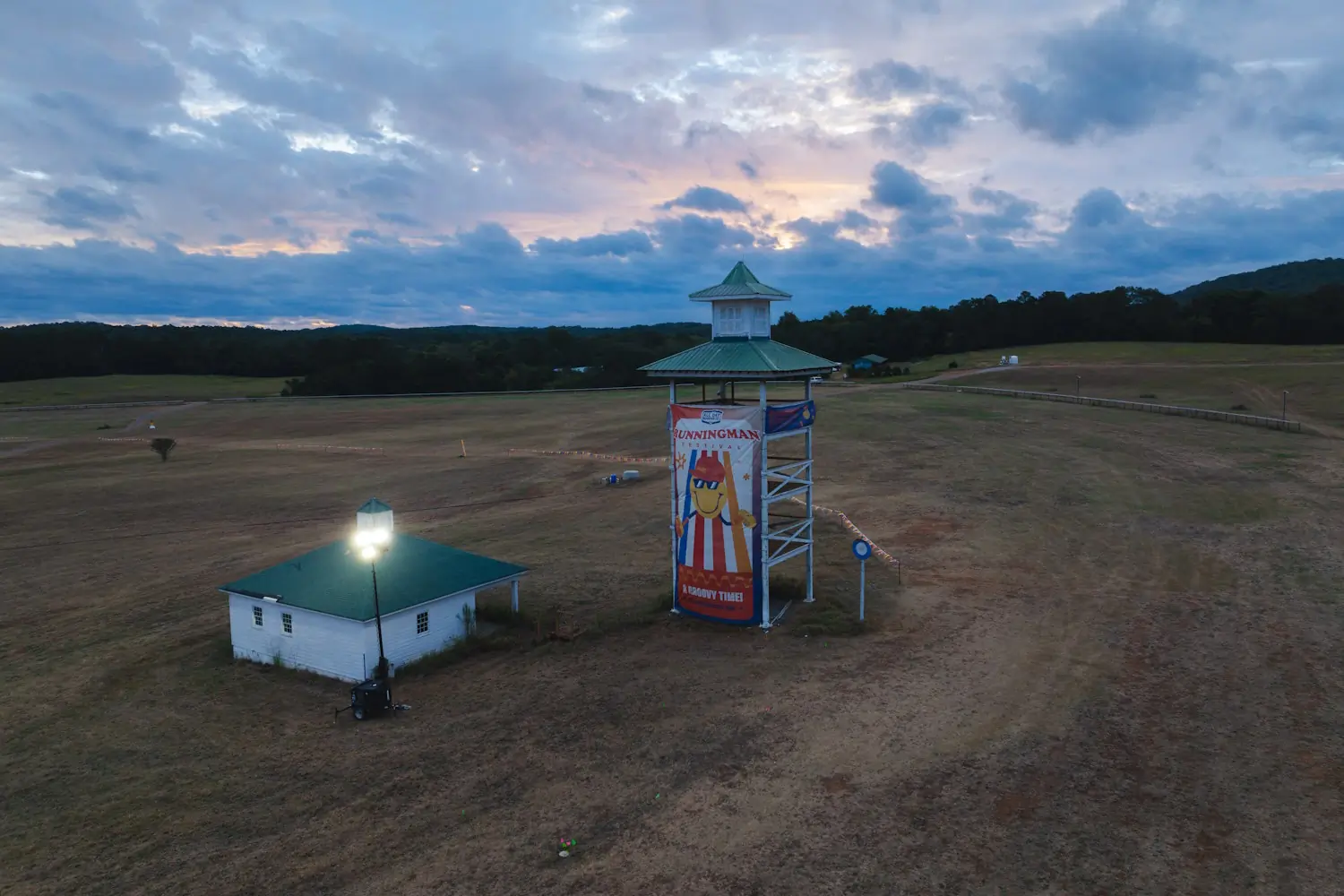 A wide view of the Running Man festival grounds at dusk
