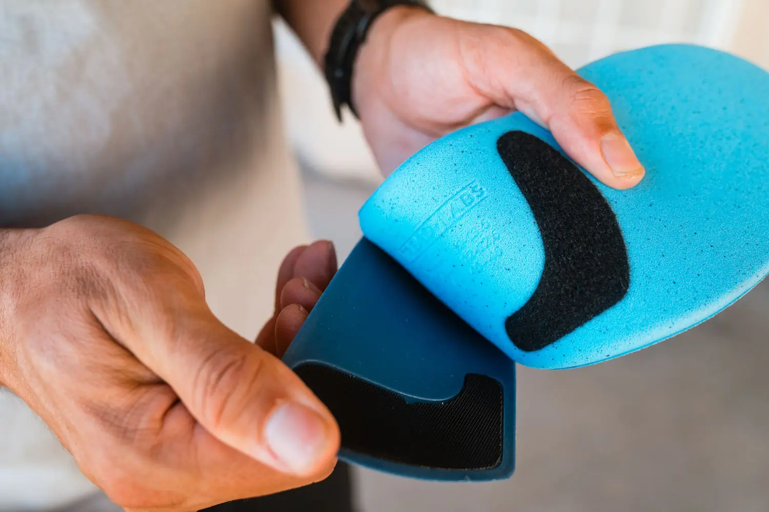 Person holding Tread Labs insole with removable top cover