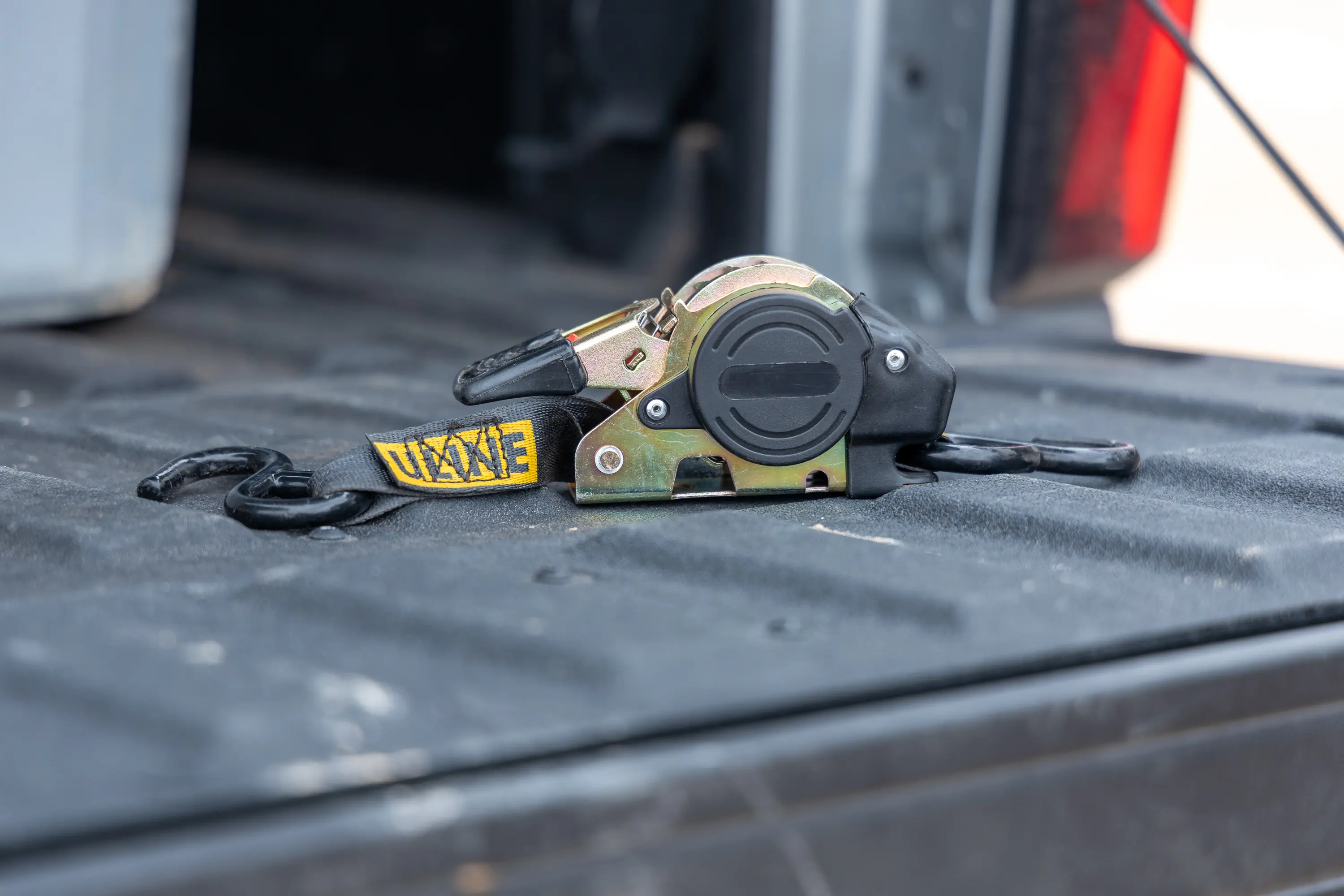 We like the rubber coating on the ratchet lever of the Uline Retractable Tie Downs; (photo/Chip Jordan)