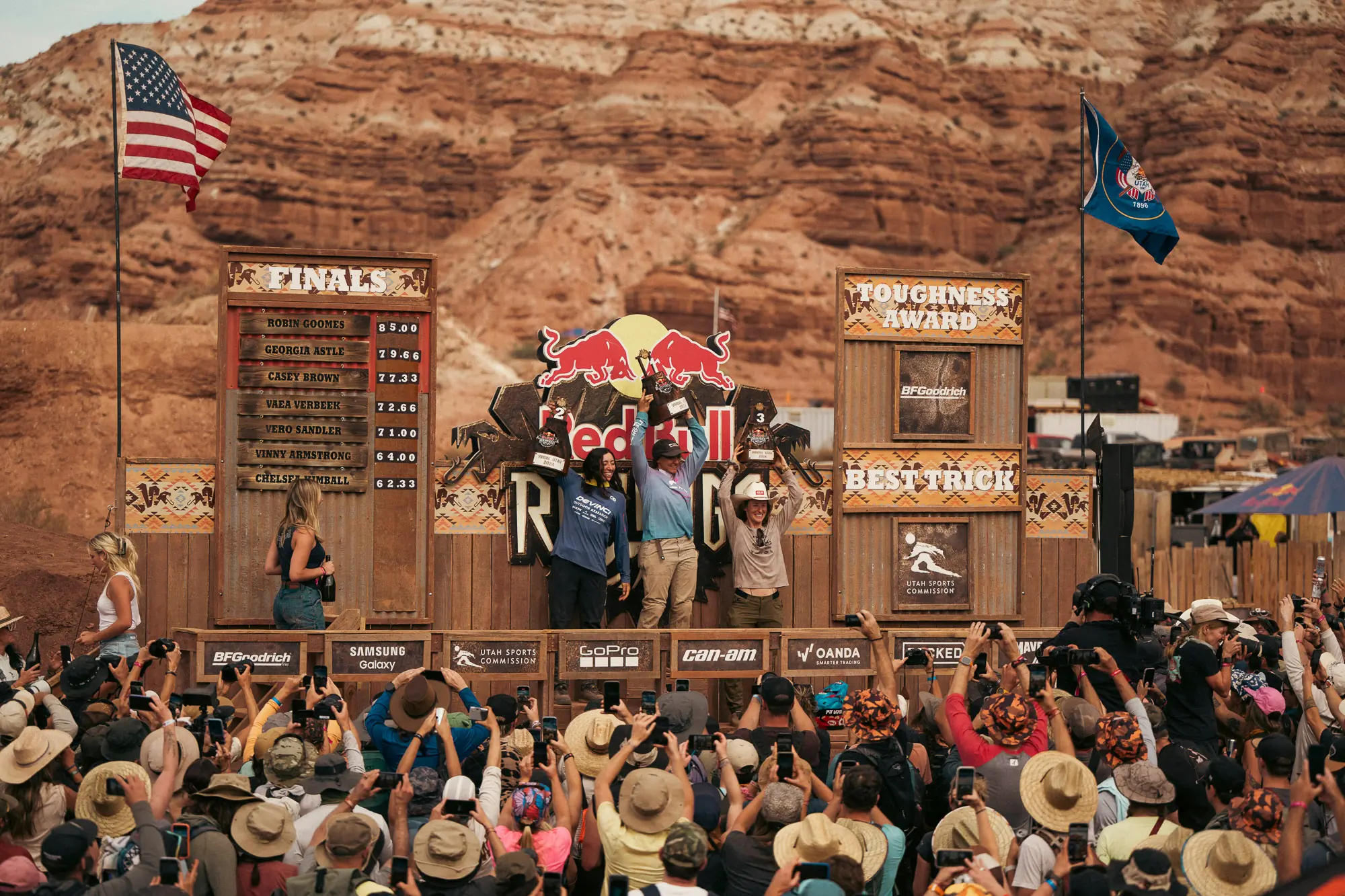 Robin Goomes, Georgia Astle and Casey Brown celebrate at the podium at Red Bull Rampage in Virgin, Utah, USA on October 10, 2024. 