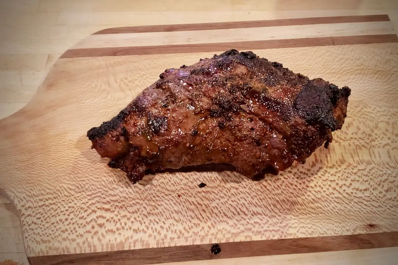 a fresh cooked tri-tip roast sitting on a cutting board