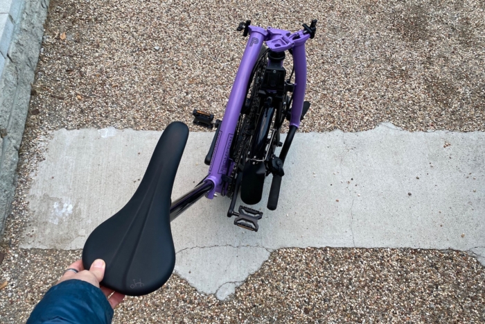 Rolling the Bromtpon P-Line Explore folding commuter bike in its folded position on its transport wheels