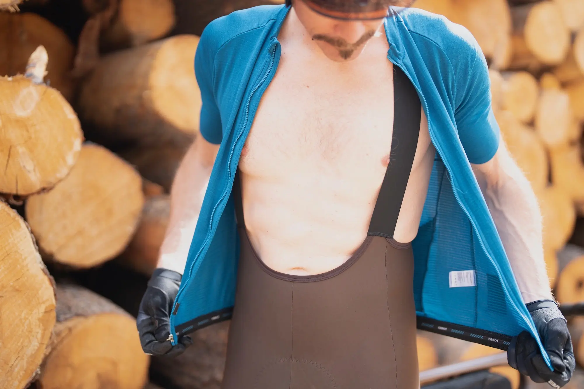 Zipping up a jersey to show the shoulder straps on the Ornot cargo cycling bibs
