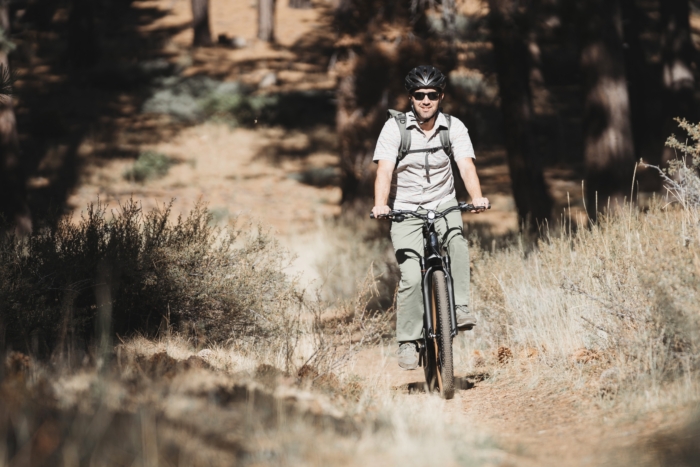 man riding the Ride1Up Prodigy V2 on some dirt trails