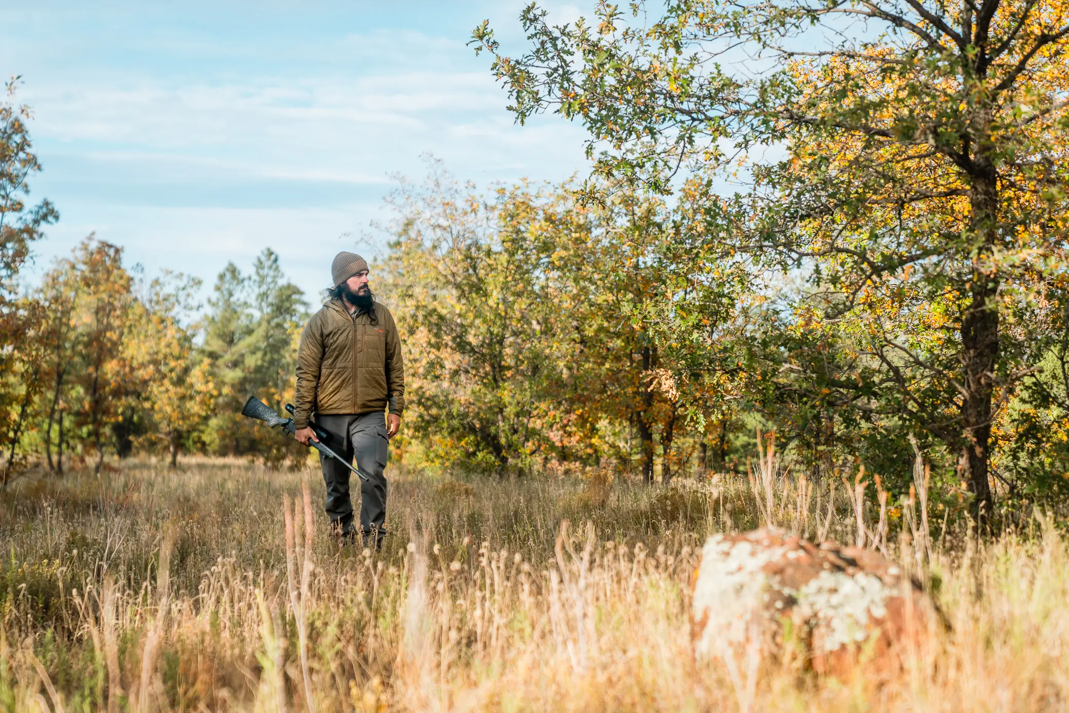 man standing on the field in hunting gear