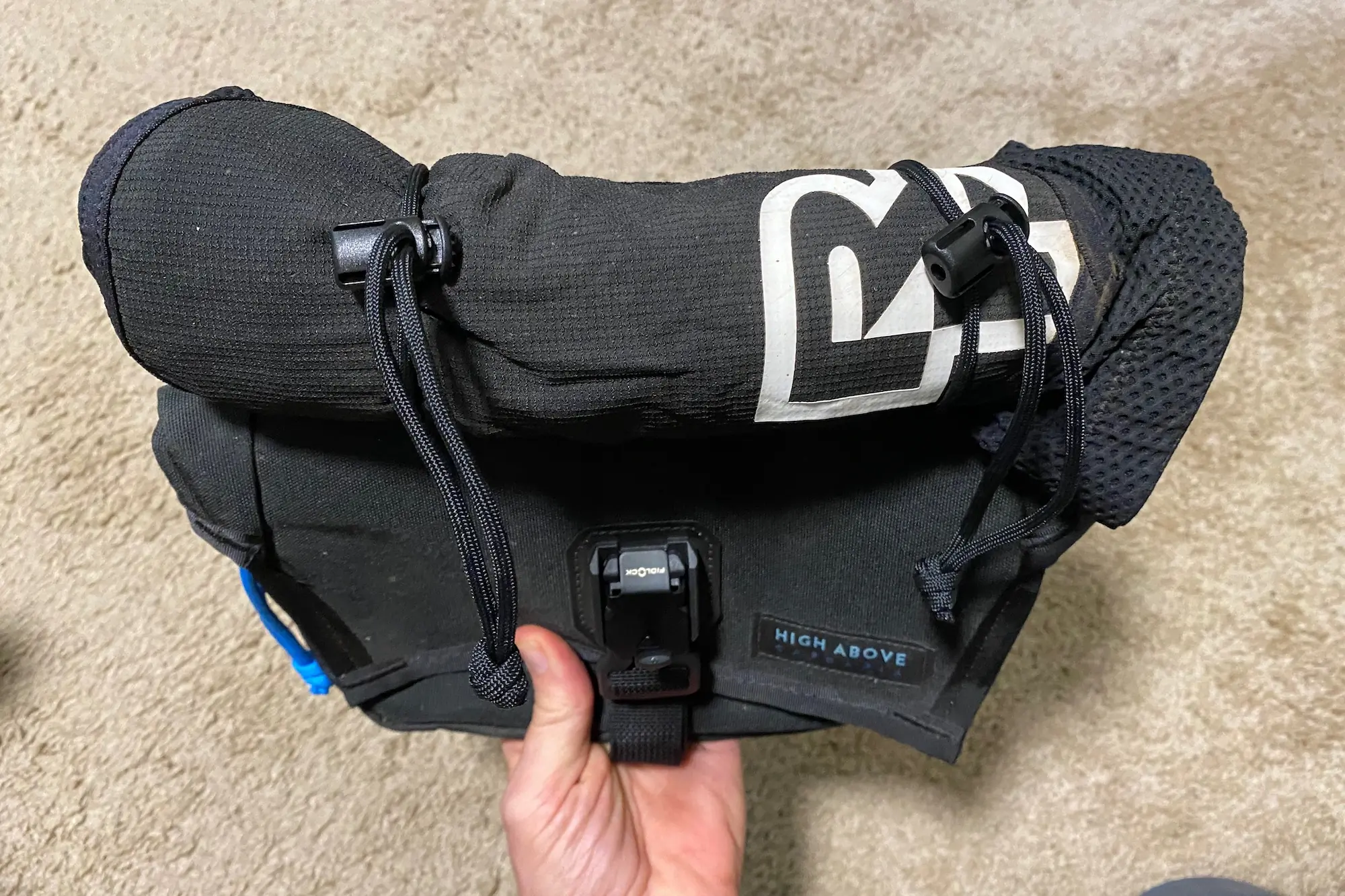 Knee pads strapped to the outside of the High Above venture Hip Pack